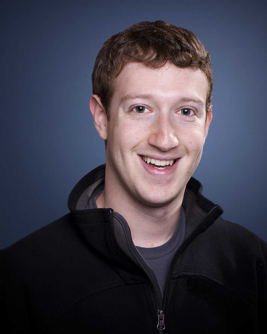 Mark Zuckerberg smiling portrait in black fleece jacket against blue studio background HD phone wallpaper