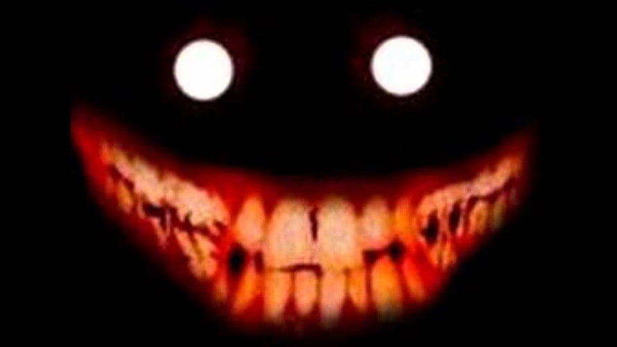 Creepypasta Scary Grinning Face with Glowing Eyes in the Dark HD wallpaper
