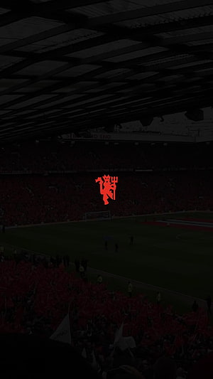 Manchester United Devil Crest Overlooking Old Trafford Stadium Pitch and Crowd HD phone wallpaper