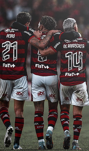 Flamengo Players Celebrating Together in Red and Black Striped Home Kits HD phone wallpaper