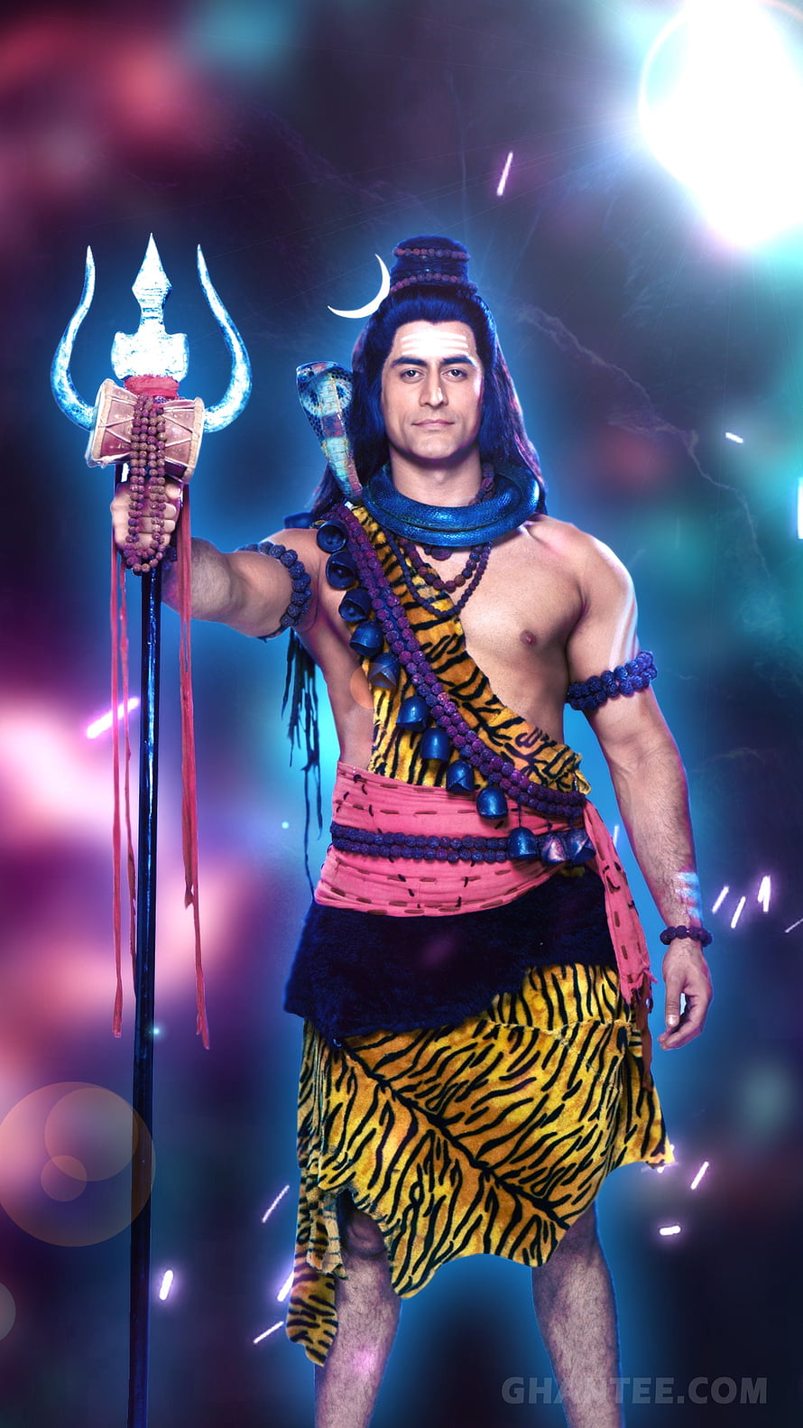 Lord Shiva in tiger skin dhoti holding trident and snake necklace with cosmic background HD phone wallpaper