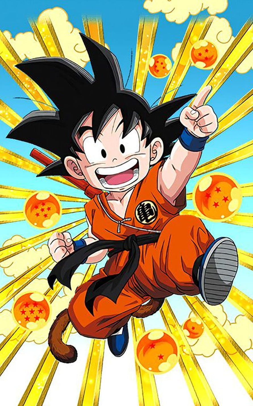 Kid Goku in Orange Gi Surrounded by Dragon Balls and Golden Light Rays HD phone wallpaper