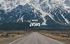 Jesus Name Above Snowy Mountain Road with Inspirational Text Overlay HD wallpaper