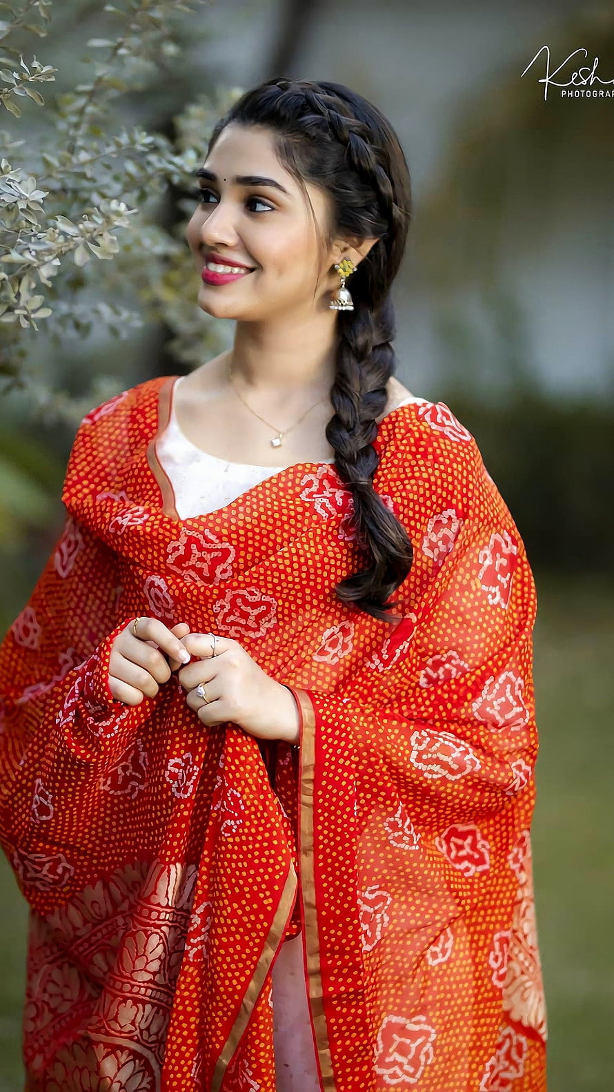 Krithi Shetty in a vibrant red Banarasi saree with a long braid and traditional jewelry HD phone wallpaper