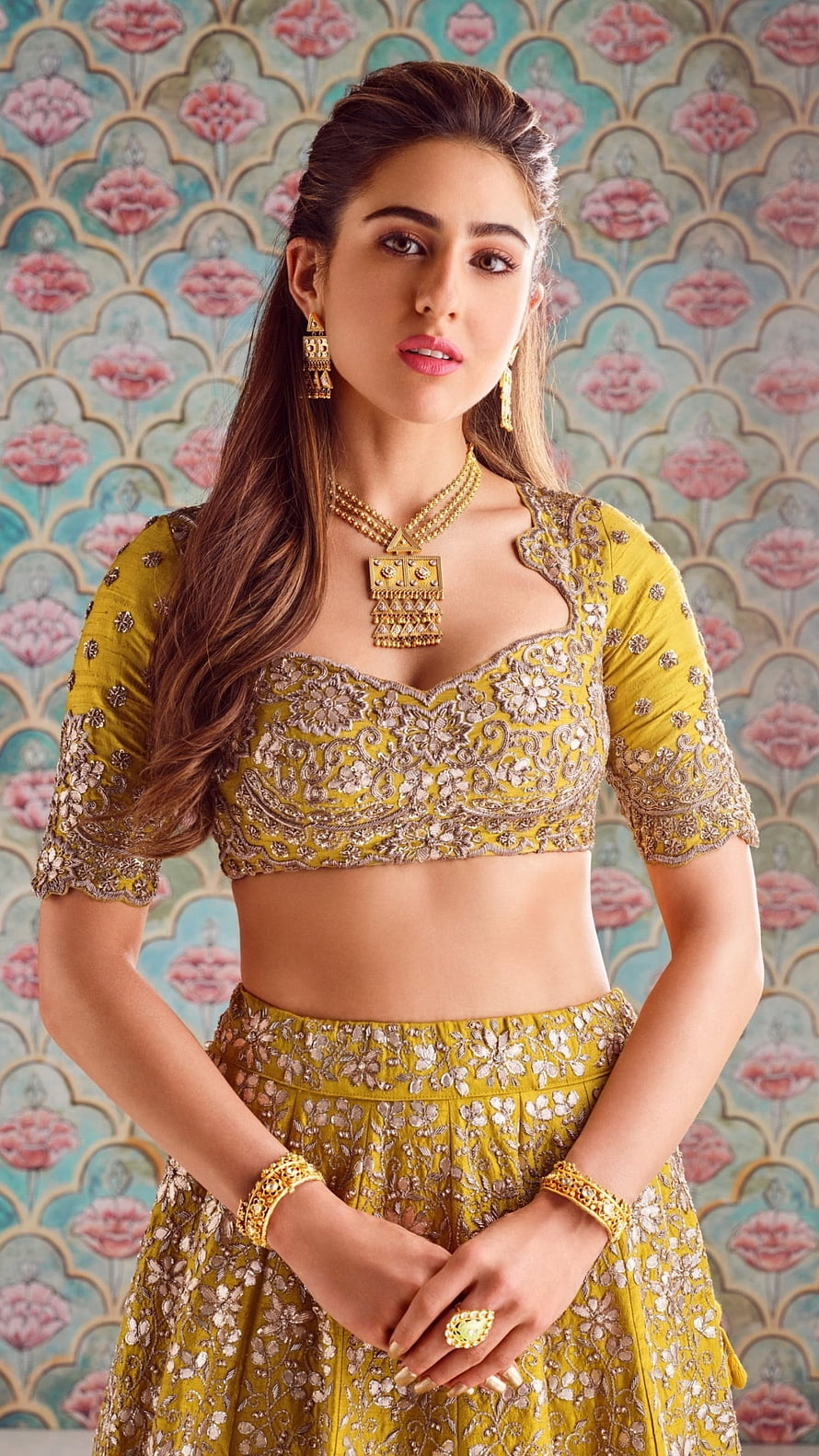 Sara Ali Khan in an ornate mustard yellow lehenga with intricate gold embroidery and traditional jewelry HD phone wallpaper