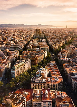 Aerial View of Barcelona Cityscape Featuring Sagrada Familia at Golden Hour HD phone wallpaper