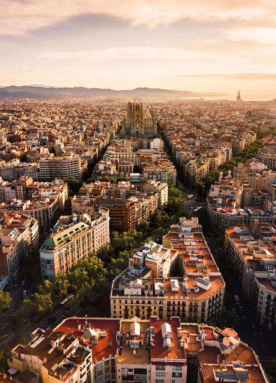 Aerial View of Barcelona Cityscape Featuring Sagrada Familia at Golden Hour HD phone wallpaper