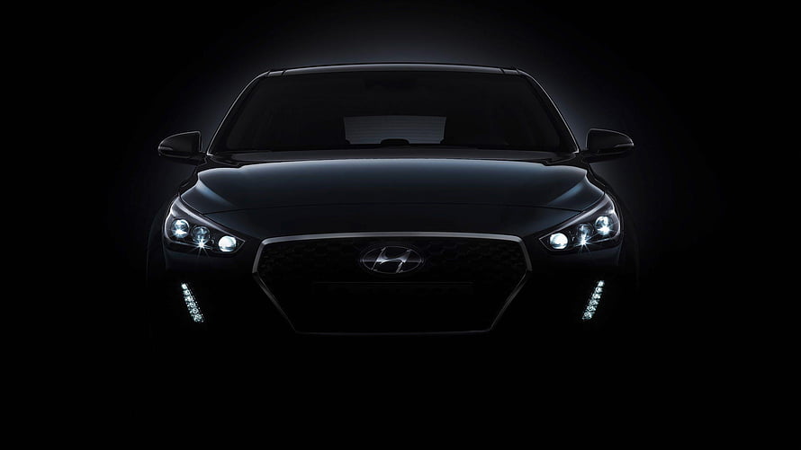Hyundai Verna Black Front View with Illuminated Headlights and Grille in Dark Studio Setting HD wallpaper