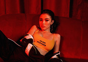 Madison Beer in Orange Crop Top and Black Jacket on Red Sofa HD wallpaper