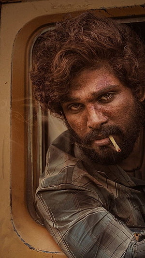 Allu Arjun as Pushpa in gritty cinematic portrait with cigarette and intense gaze HD phone wallpaper