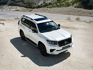 White Toyota Land Cruiser Prado SUV Parked on Gravel Quarry Ground HD wallpaper