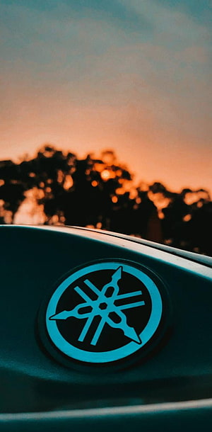 Yamaha Tuning Fork Emblem on Motorcycle Tank Against Golden Sunset Sky HD phone wallpaper