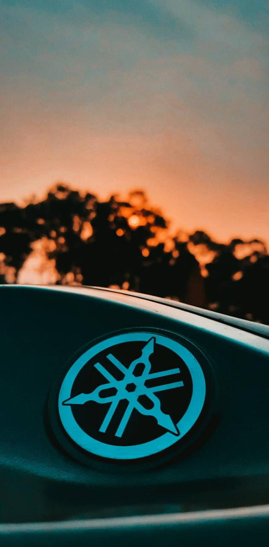 Yamaha Tuning Fork Emblem on Motorcycle Tank Against Golden Sunset Sky HD phone wallpaper