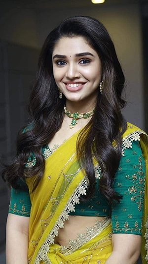 Krithi Shetty in a Vibrant Yellow and Green Saree with Gold Embroidery HD phone wallpaper