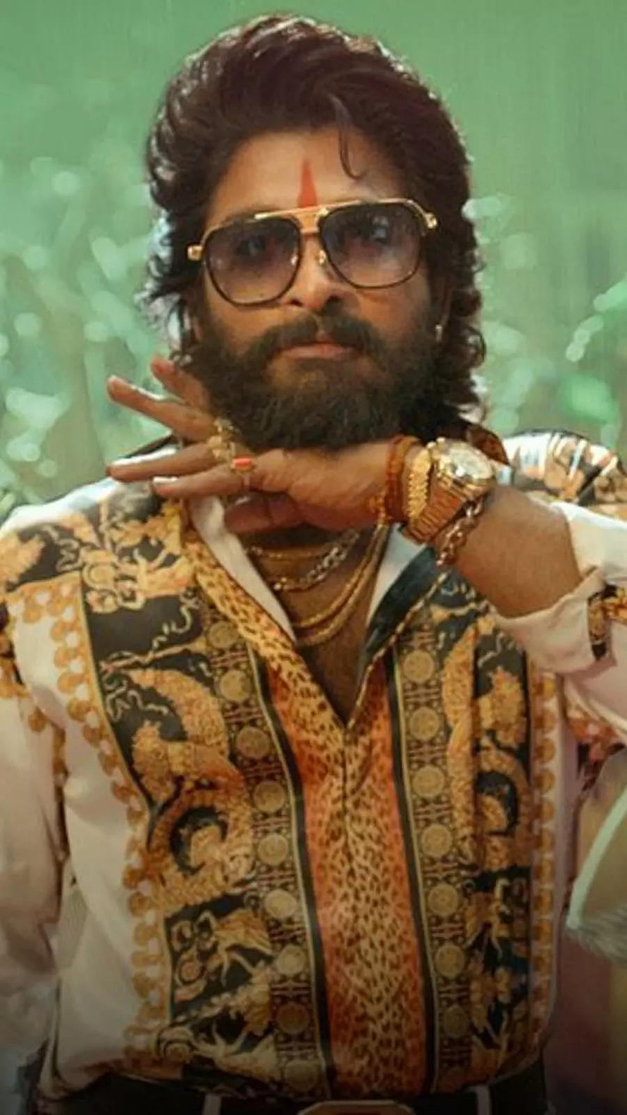 Pushpa Raj in ornate gold-patterned shirt with aviator sunglasses and red tilak HD phone wallpaper