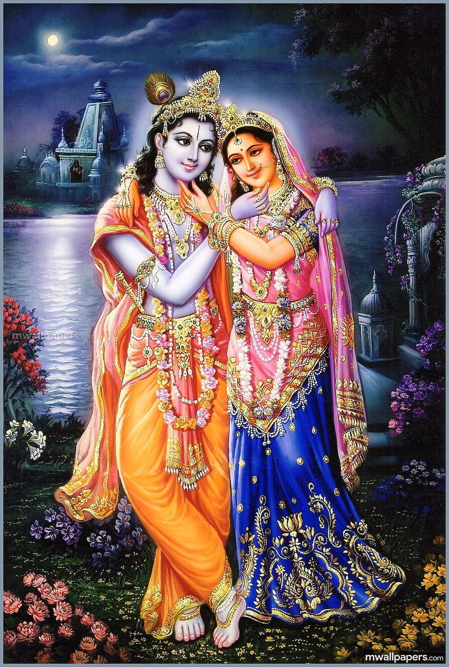 Radha Krishna in ornate traditional attire embracing under a full moon beside a serene river HD phone wallpaper