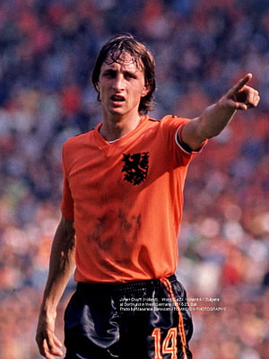 Johan Cruyff in the Netherlands orange jersey pointing during a 1974 World Cup match HD phone wallpaper
