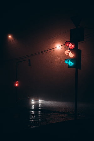 Moody Night Street Scene with Glowing Traffic Lights and Foggy Road HD phone wallpaper