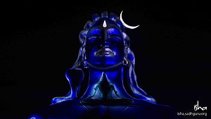 Adiyogi Shiva Statue Illuminated in Deep Blue with Crescent Moon and Isha Foundation Logo HD wallpaper