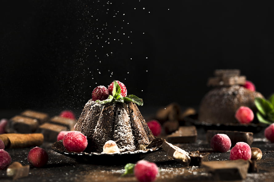 Dark Chocolate Canelé Cake Topped With Fresh Raspberries And Mint On A Black Background HD wallpaper
