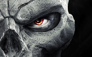 Close-Up of a Cracked Stone Skull with a Glowing Red Eye in Dark Fantasy Style HD wallpaper