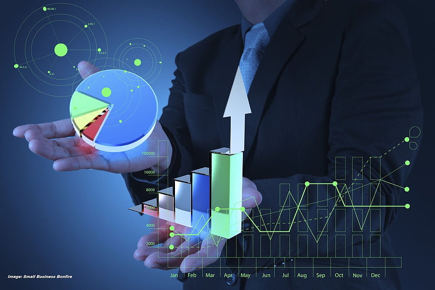 Businessman Holding 3D Pie Chart and Rising Bar Graph with Financial Data Visualization HD wallpaper