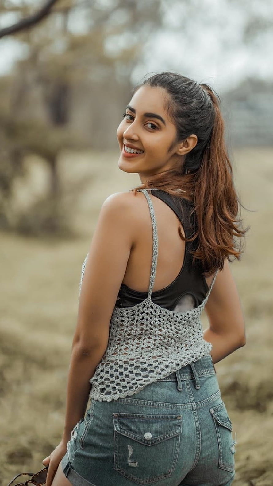 Simrat Kaur in Crochet Top and Denim Shorts in a Natural Outdoor Setting HD phone wallpaper