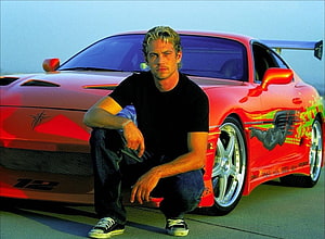 Paul Walker Crouching in Front of a Red Toyota Supra with Custom Graphics HD wallpaper