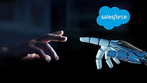 Salesforce AI Concept: Human and Robotic Hands Reaching Toward Each Other in Dark Setting HD wallpaper