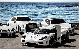 White Supercar Collection Featuring Rolls-Royce, Koenigsegg, and Mercedes-Benz Parked by the Sea HD wallpaper