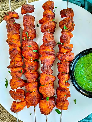 Baked Chicken Tandoori Tikka Skewers with Fresh Mint Chutney on a White Plate HD phone wallpaper