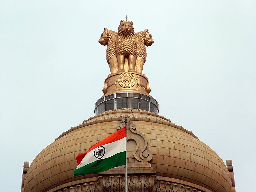 Golden Lion Capital of Ashoka atop the Indian Parliament Building with National Flag HD wallpaper