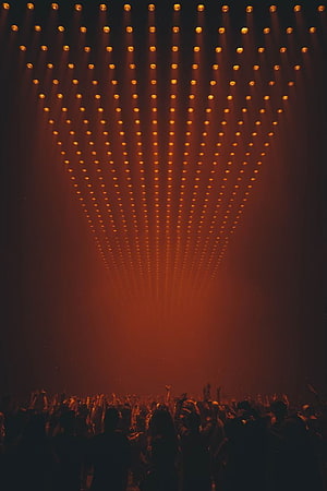 Dramatic Orange Stage Lighting Array Over Silhouetted Concert Audience HD phone wallpaper
