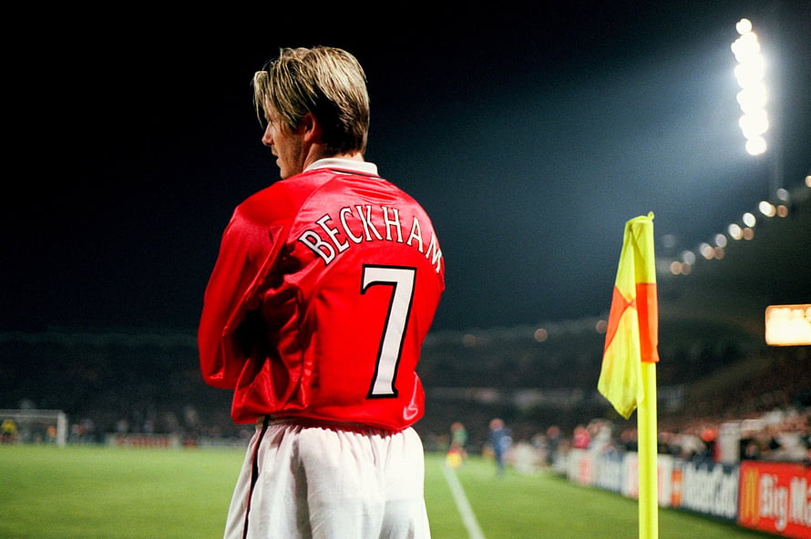 David Beckham in Manchester United red jersey number 7 on the football pitch at night HD wallpaper