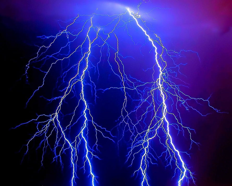 Vivid Blue and Purple Lightning Bolts Striking Through a Dark Stormy Sky HD wallpaper