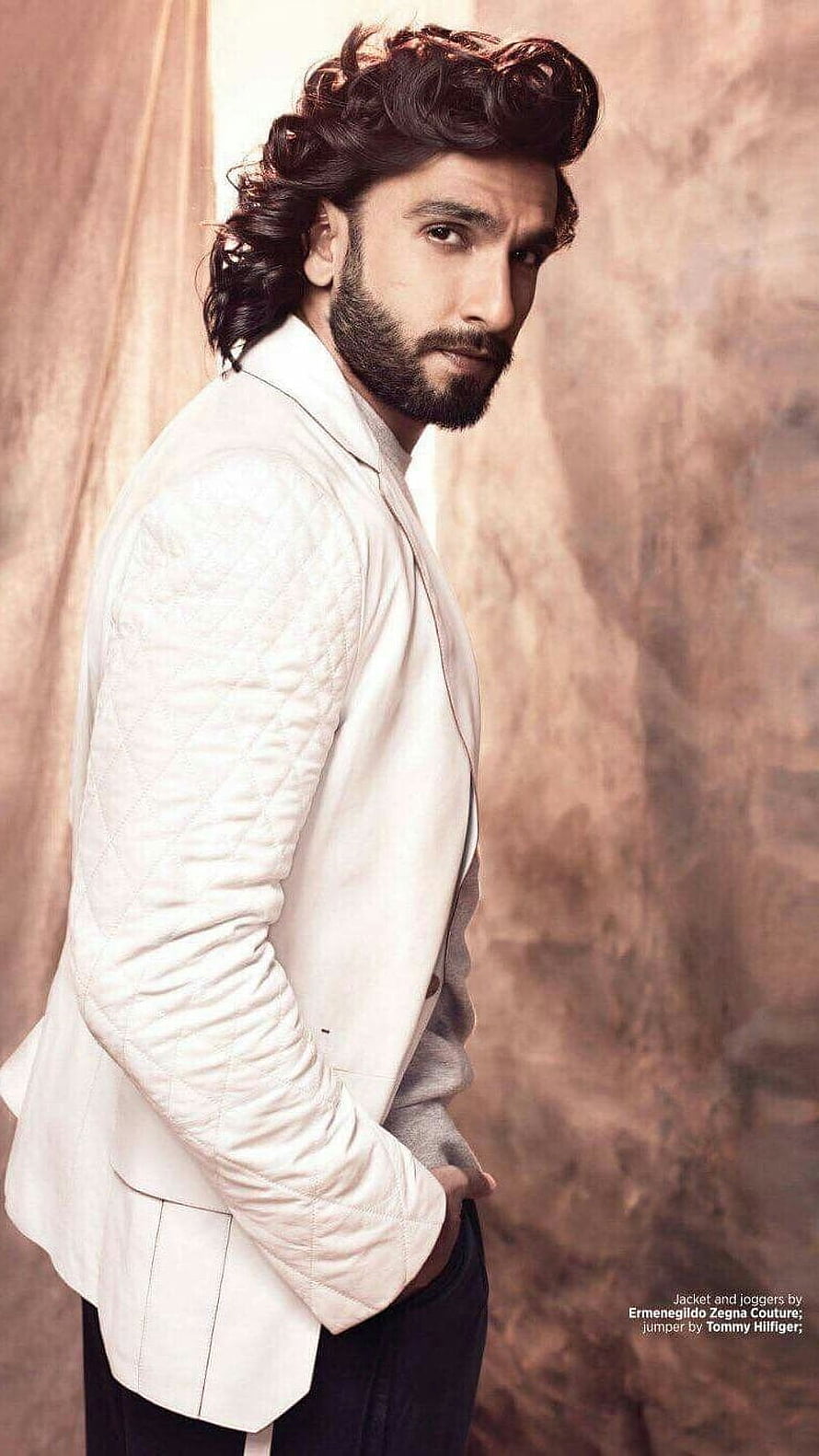 Ranveer Singh in a white quilted blazer and dark trousers against a warm textured backdrop HD phone wallpaper