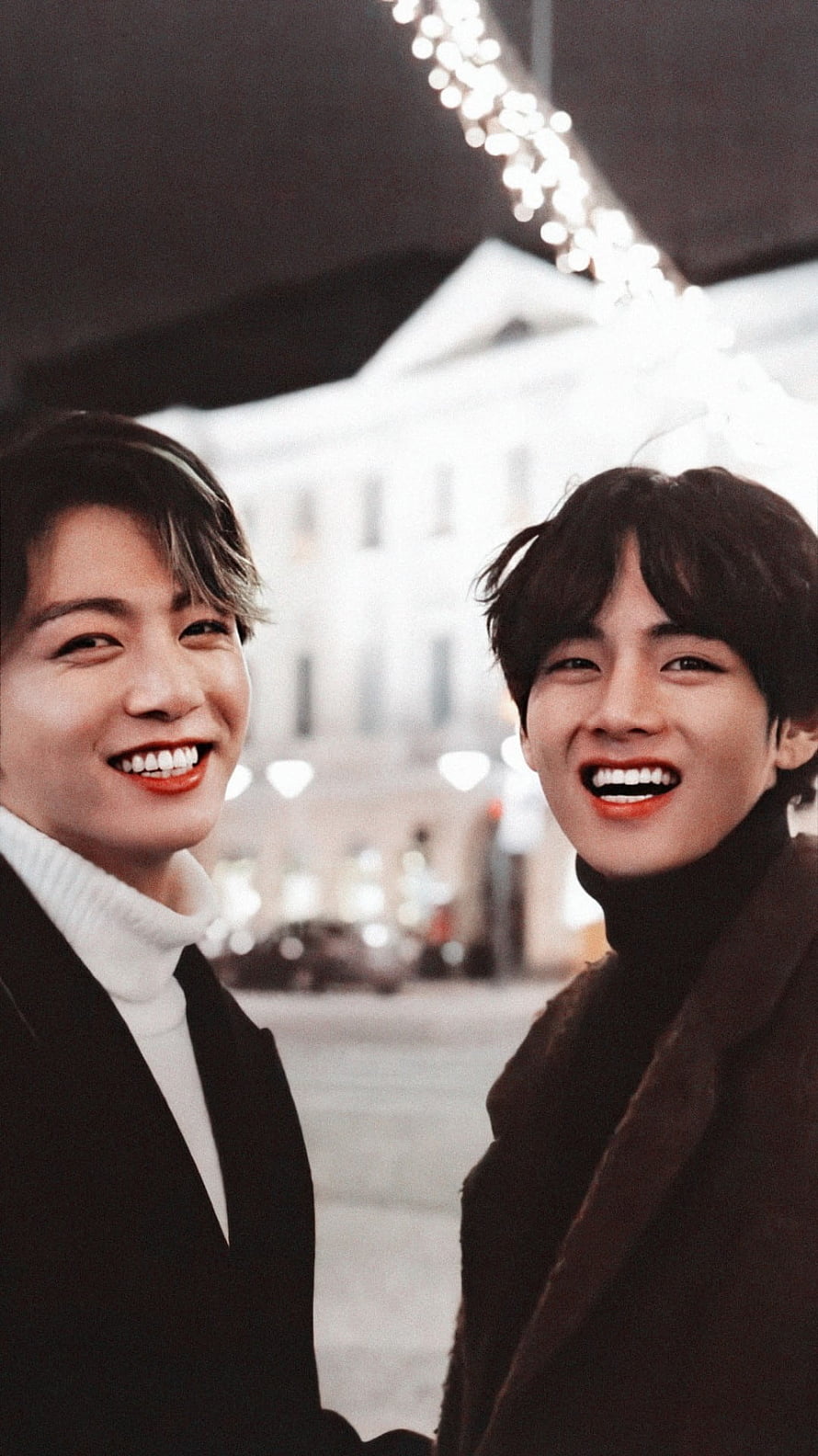 BTS Taekook smiling together in a European city street at night HD phone wallpaper