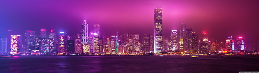 Hong Kong skyline at night with purple and pink neon lights reflecting on the harbor water HD wallpaper