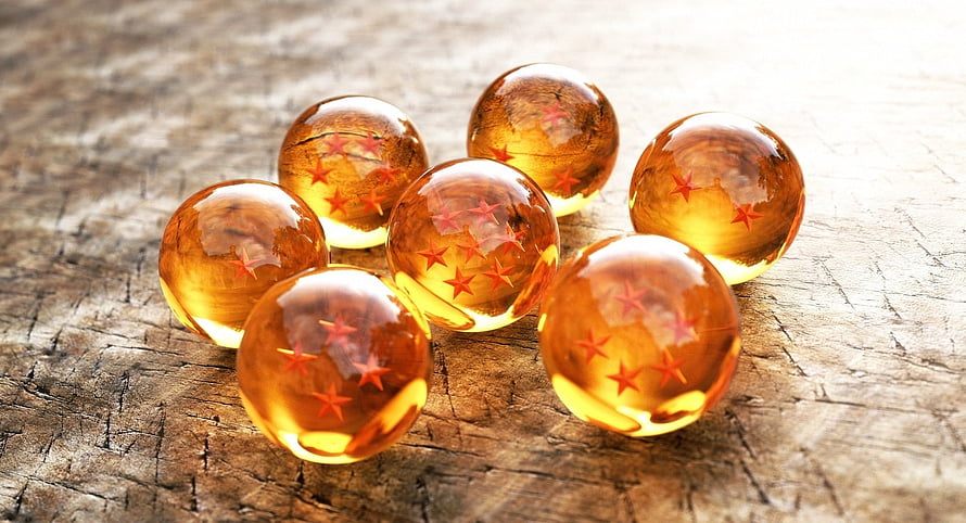 Dragon Ball Z Crystal Orbs with Red Stars on Rustic Wooden Surface HD wallpaper