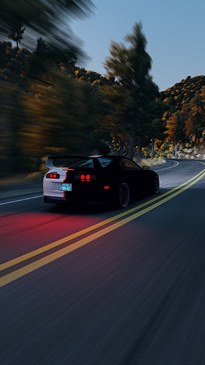 Black Toyota Supra MK4 Driving on a Winding Mountain Road at Dusk HD phone wallpaper