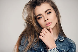 Studio Portrait of a Young Woman in a Denim Jacket with Windblown Hair HD wallpaper