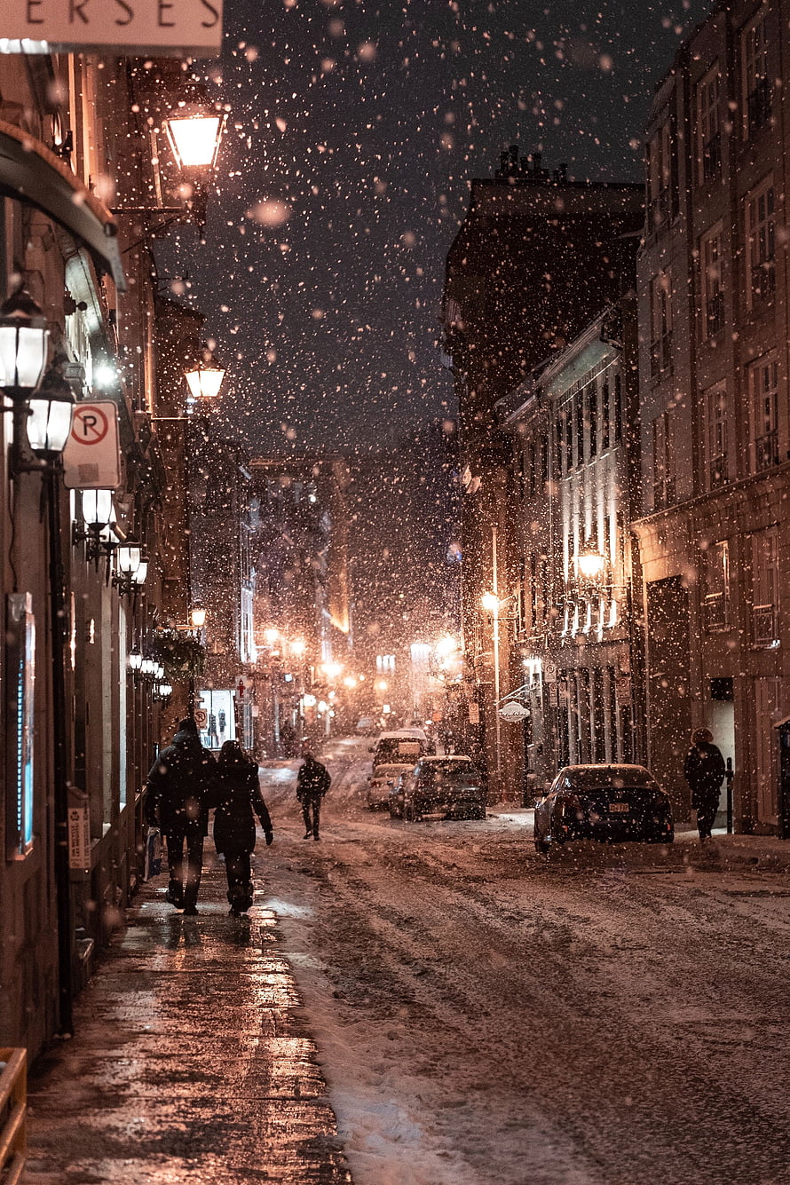 Snowy City Street at Night with Pedestrians and Warm Streetlights HD phone wallpaper