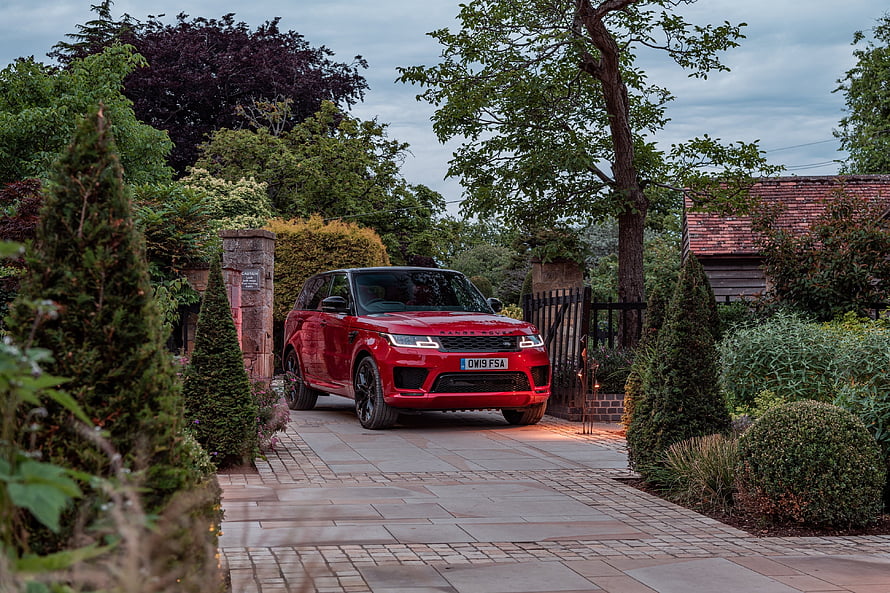 Red Range Rover Sport SUV Parked on a Lush Garden Driveway HD wallpaper
