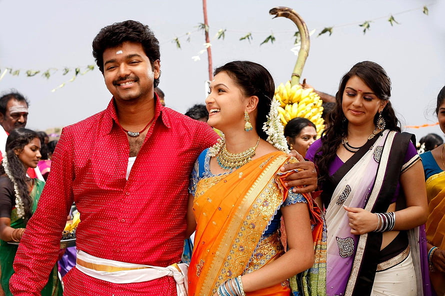 Vijay and Trisha in traditional attire during a festive procession scene from the Tamil film Velayudham HD wallpaper