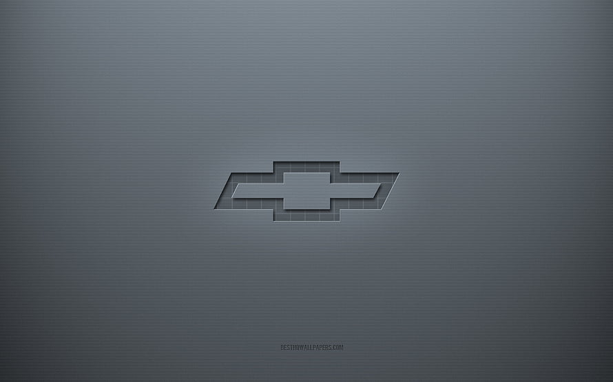 Chevrolet Bowtie Emblem on Textured Gray Surface with Subtle 3D Depth and Minimalist Design HD wallpaper