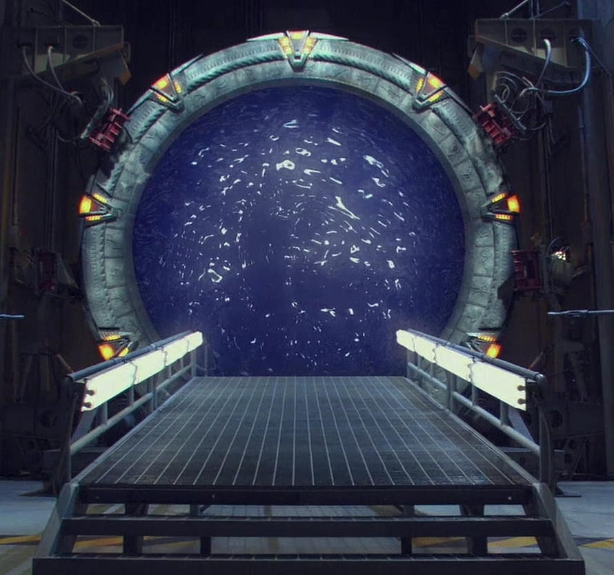 Stargate SG-1 Wormhole Portal with Metallic Walkway and Industrial Sci-Fi Setting HD wallpaper