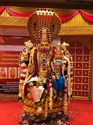 Lakshmi Narasimha Swamy Temple Idol with Serpent Hood and Floral Garlands HD phone wallpaper