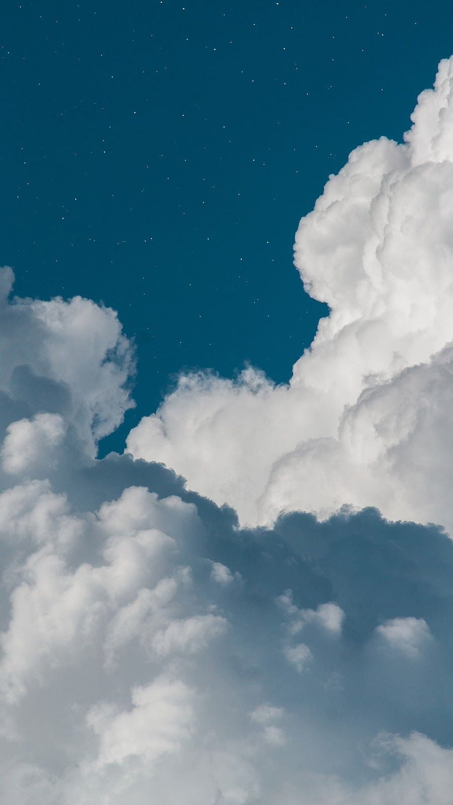 Dramatic Cumulus Clouds Against a Deep Blue Starry Sky HD phone wallpaper