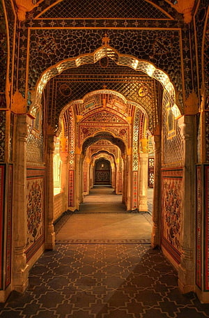 Ornate Mughal Archway Corridor with Intricate Floral Tilework and Geometric Patterns HD phone wallpaper
