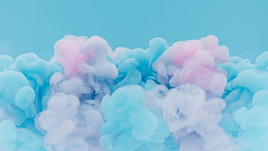 Soft Pastel Pink and Blue Ink Clouds Billowing in Water Against a Light Blue Backdrop HD wallpaper